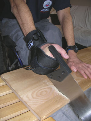 The user sawing using the gripping aid. Photo: www.activehands.co.uk